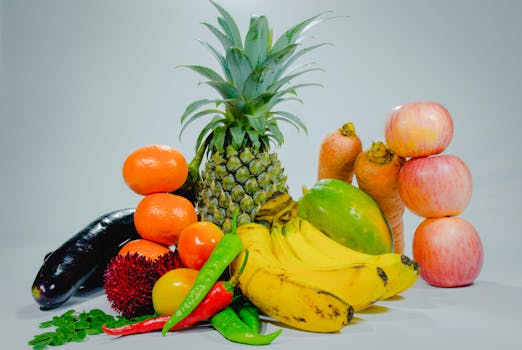 bowl of fresh fruits including bananas and apples