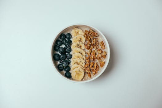 Image of a smoothie bowl topped with fruits and nuts