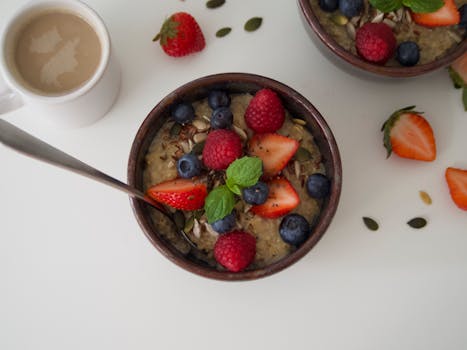 bowl of oatmeal topped with chia seeds and fruit